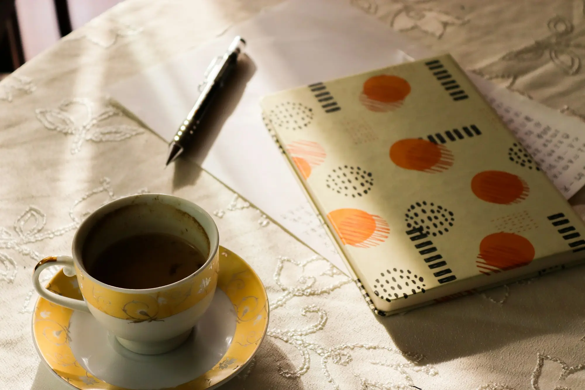 Cup of coffee beside an open notebook, ready to prepare a loan application