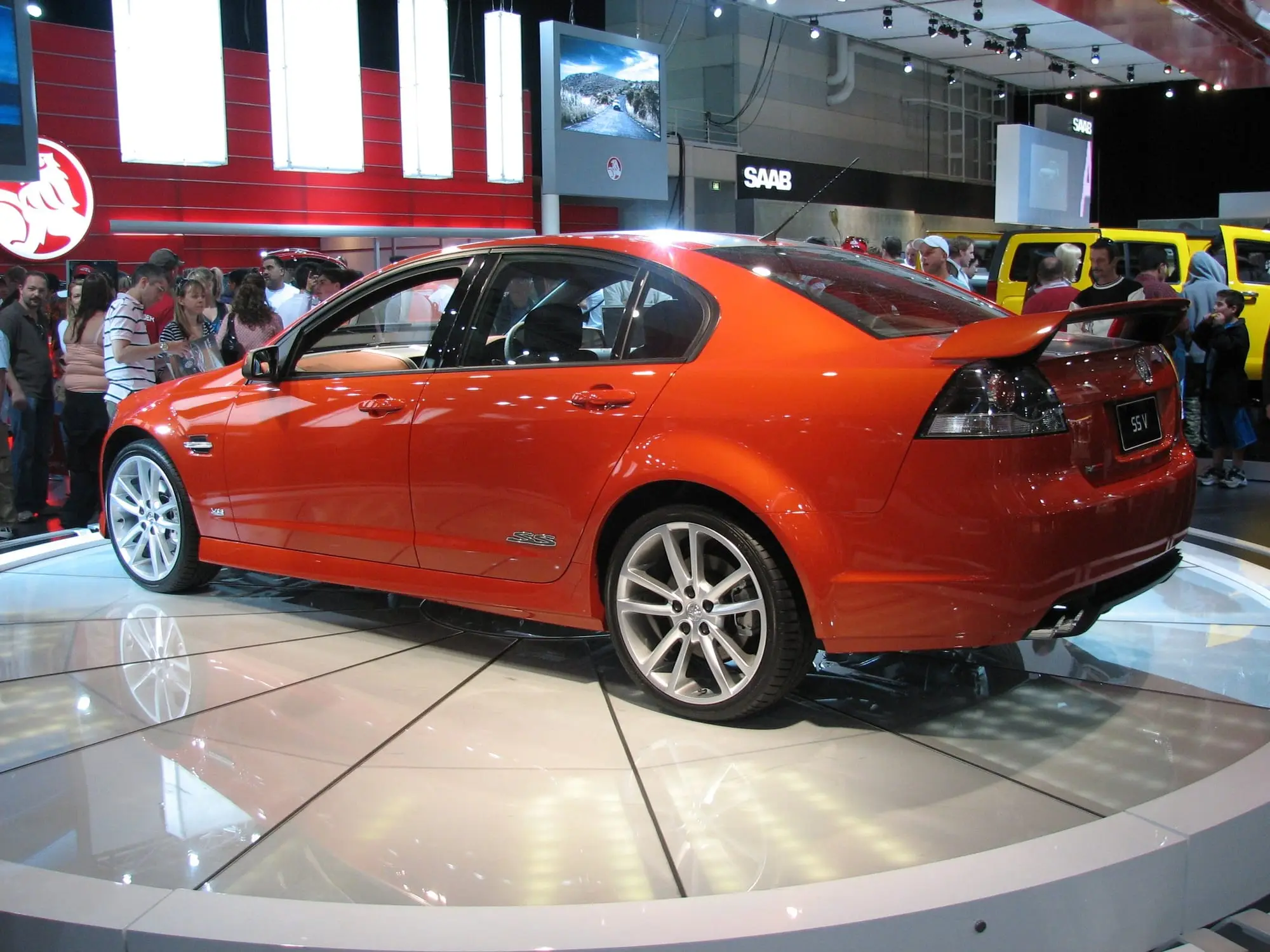 Orange Holden VE Commodore SS V sedan on a motor show stand