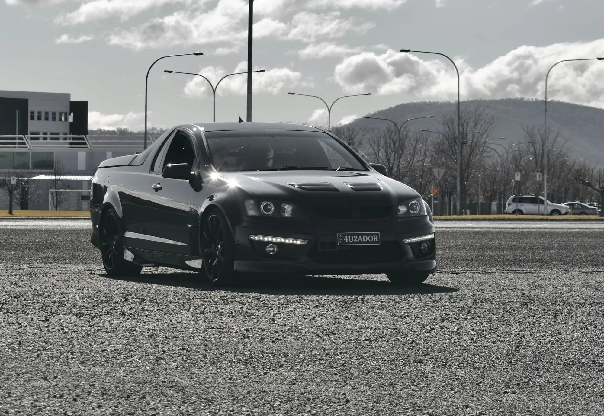 Black HSV Maloo performance ute shot from a low angle on an empty car park
